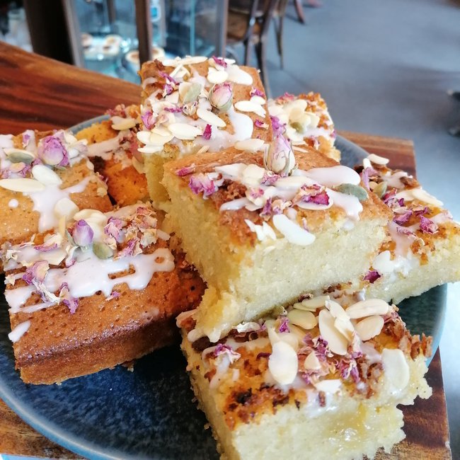 Persian Love cake: a fragrant rose cake flavored with freshly ground cardamom and almond flour, and topped with crushed pistachios and rose petals